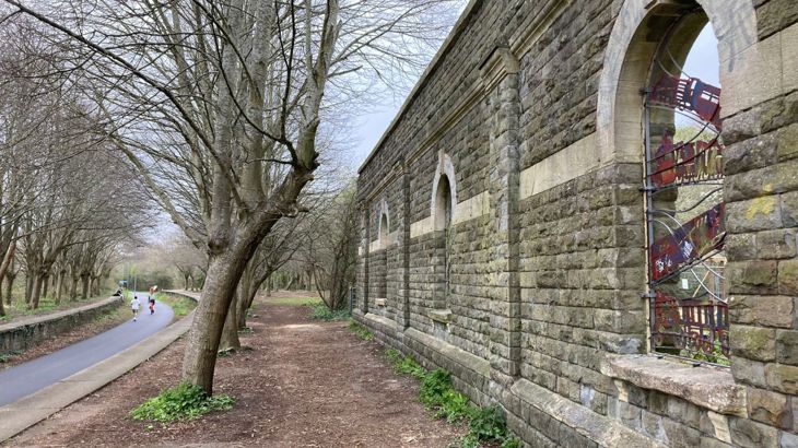 Mangotsfield station on Bristol and Bath Railway Path - remaining wall and platform from old railway station, active travel path runs along old rail line.