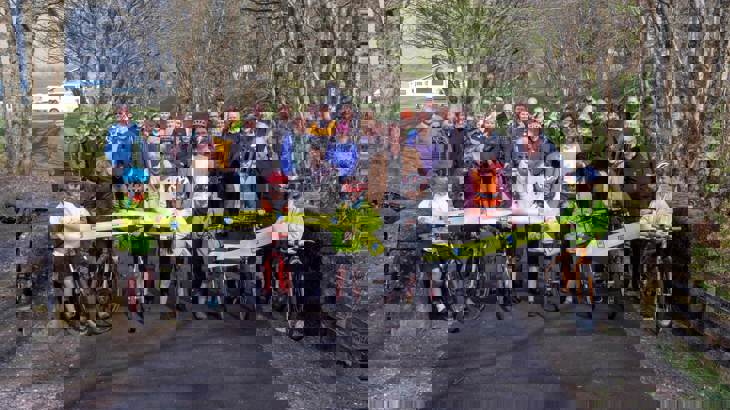 Group of people cutting the ribbon at opening of new walking and cycling path