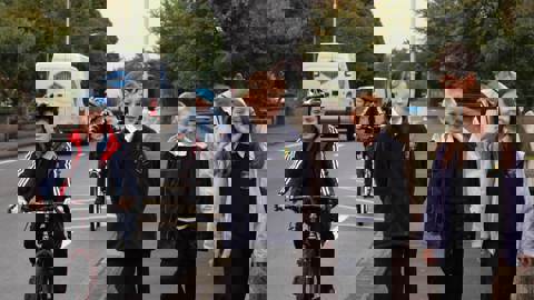 Children in school uniform walking and cycling 