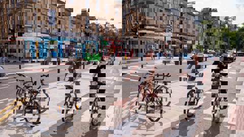 Two cyclists in a protected cycle lane