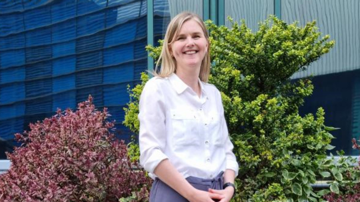  A young blonde white woman called Karen stood smiling and wearing a white shirt