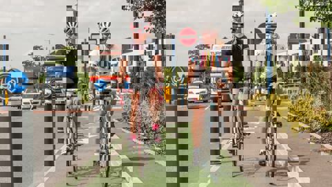 woman on bikes cycling in protected lane in a city