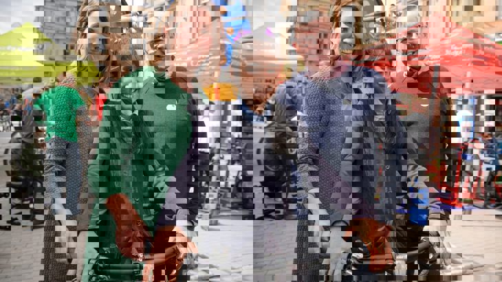 Walk Wheel Cycle Trust in Scotland Director John Lauder with a member of the community and a school child on a bicycle at a street event