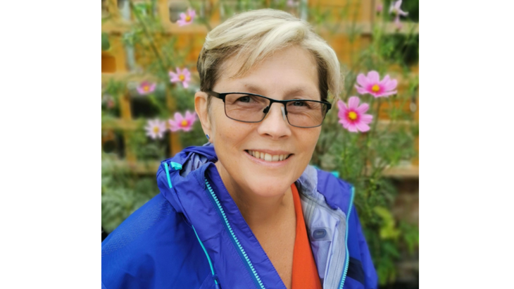 Walk Wheel Cycle Trust community engagement officer in waterproof jacket in green space