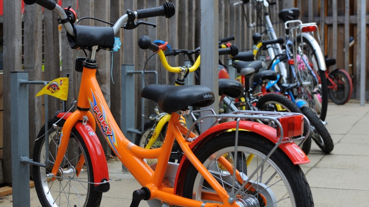 bicycles of many sizes in a stand