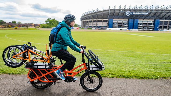 Person rides cargo bike at Murrayfield Stadium in Edinburgh