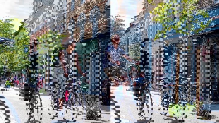 Male and female coworkers cycling side by side