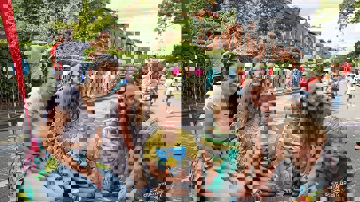 Families drawing on the street of a street party closure