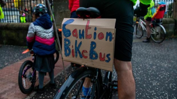 Bicycle with handmade sign that reads 'Caution bike bus'.