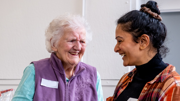 Two people are shown chatting during an event at Perth Creative Exchange