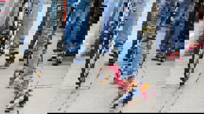 Adults and children walking and scooting 