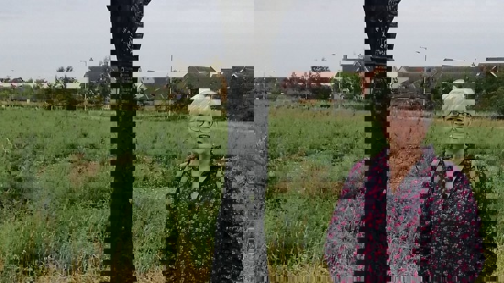 Penny stood next to a millennium milepost on the National Cycle Network