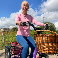 Walk Wheel Cycle Trust volunteer with cerebral palsy using her etrike in Belfast.
