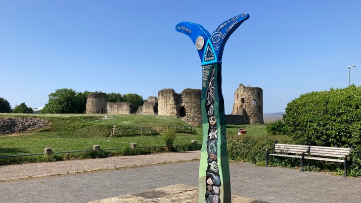 A Millennium Milepost on NCN 5 in front of Flint Castle.