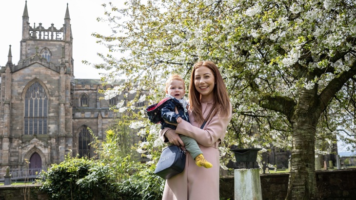 A mum and her young son are shown in front of the Dunfermline Abbey.