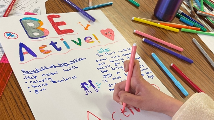 A poster being drawn by one of the 2nd Newtown Guides as part of the Active Adventures badge launch.