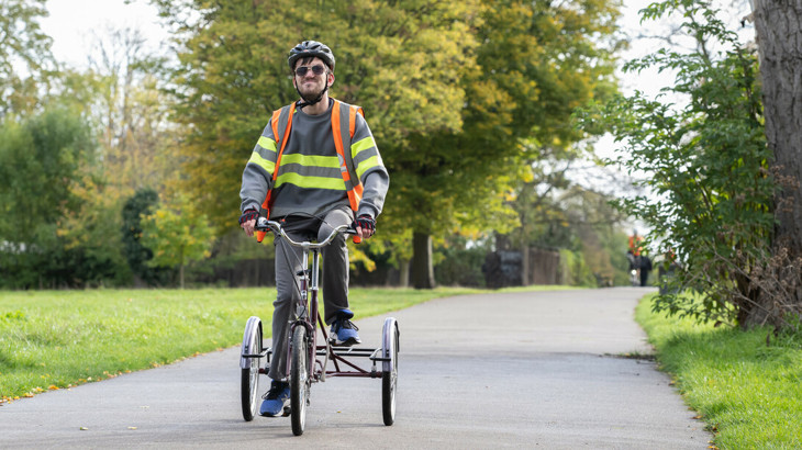 Riding upright trike along path in Brockwell Park, London
