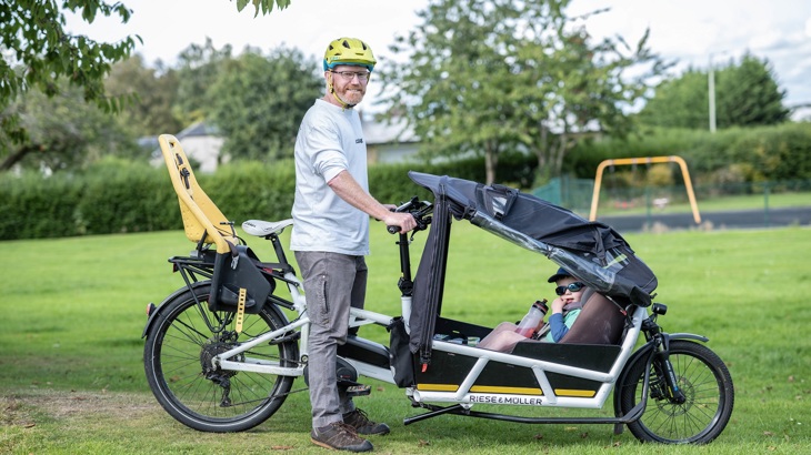 Robin is pictured with the cargo bike he and his family use