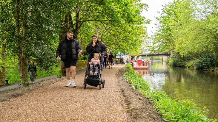 family walking along a canal towpath