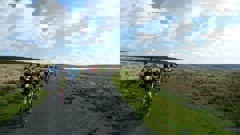 People cycling along a traffic-free National Cycle Network route in Land's End.