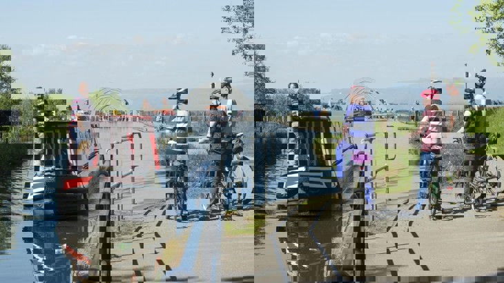 Family Cycling By Canal