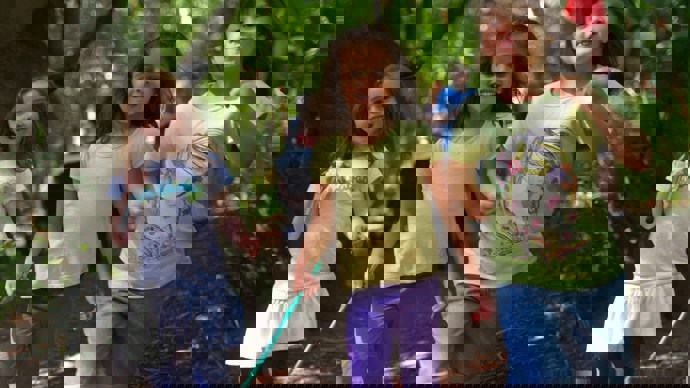 Three children playing in forest