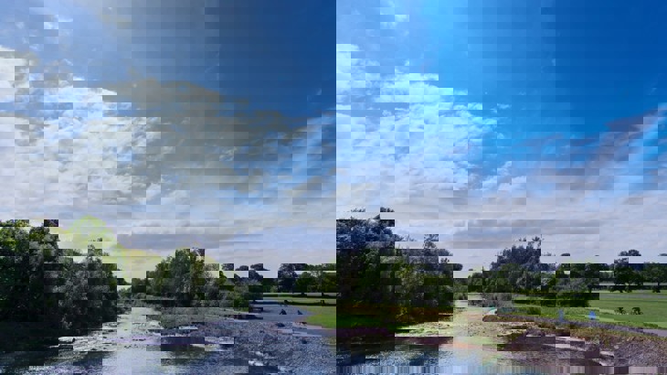 River with cycle path going alongside it in park