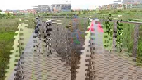 people on bikes near new housing development