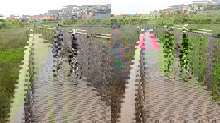 people on bikes near new housing development