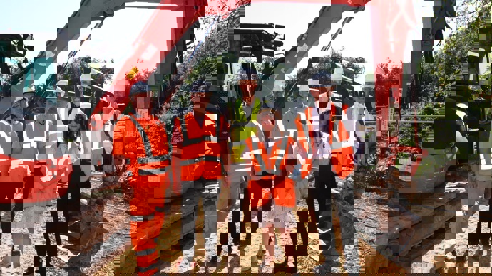 Councillors visit the project on Castleford Greenway and stand in front of a digger used in the construction