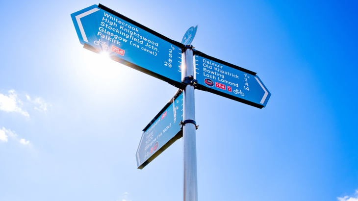 National Cycle Network Route signs against a sunny, blue sky at Clydebank.