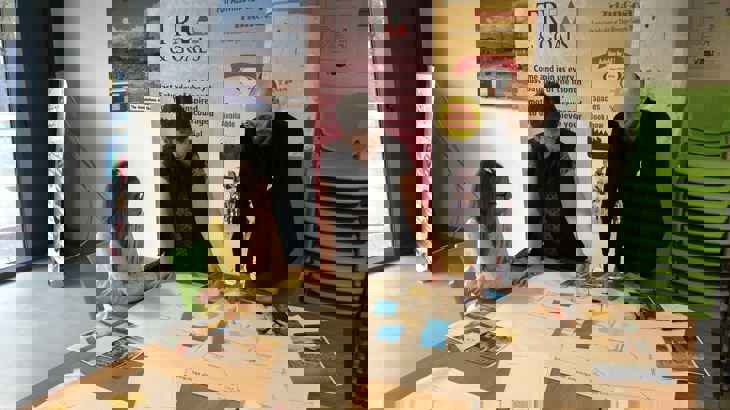 People stand around a table at a Collaborative Design Workshops For The Ripple Greenway Design