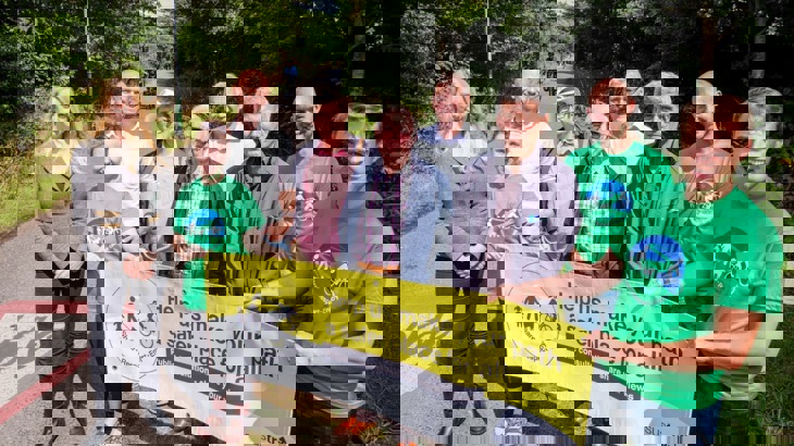 Walk Wheel Cycle Trust staff pose with local residents by the side of the Bristol and Bath Railway Path, holding a public consultation banner.