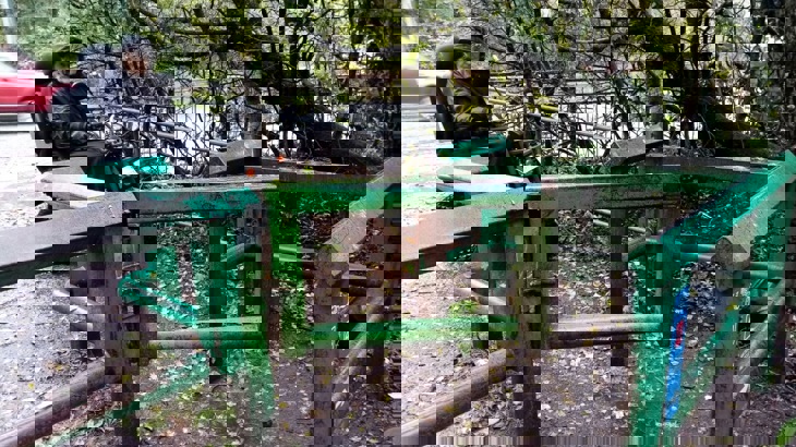 A person on a mobility scooter next to a metal gate