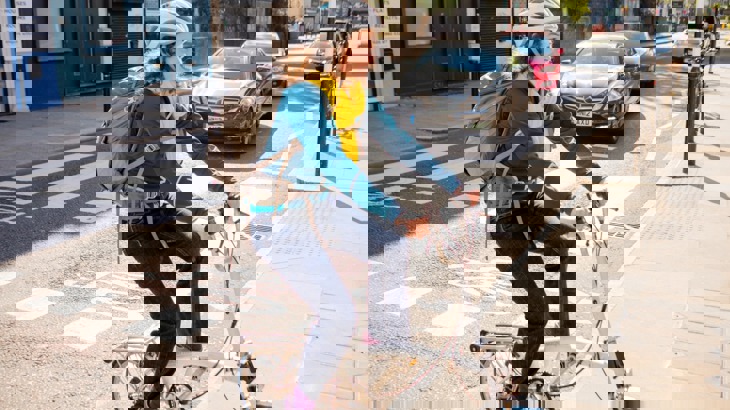 woman on folding bike zebra crossing