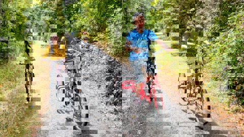 An adapted bicycle and a push  bike ride along a traffic-free path