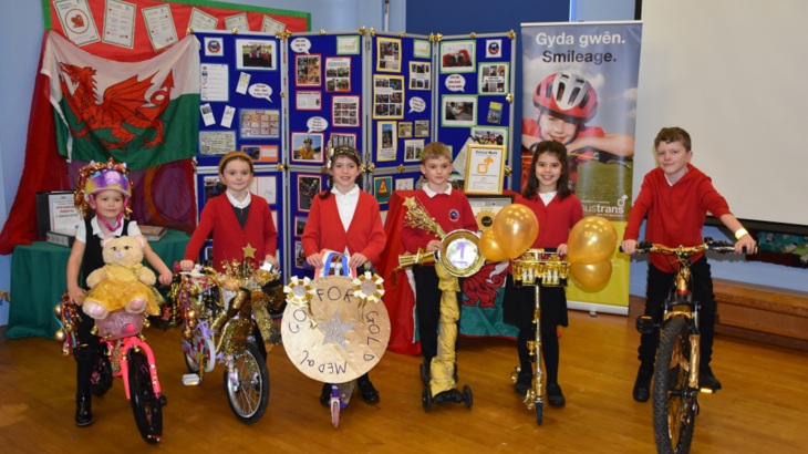 Children at Coychurch Primary school celebrate receiving the Walk Wheel Cycle Trust Gold School Mark award.