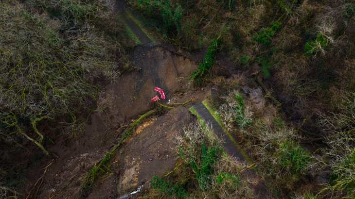 Areal shot from above of a huge landslip severing the path of NCN route 47