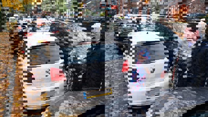 Family walking across a gridlocked road outside the school gates