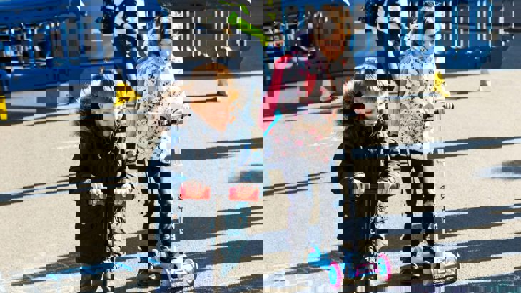 Two children playing outside on their scooters during a School Streets closure in Southampton