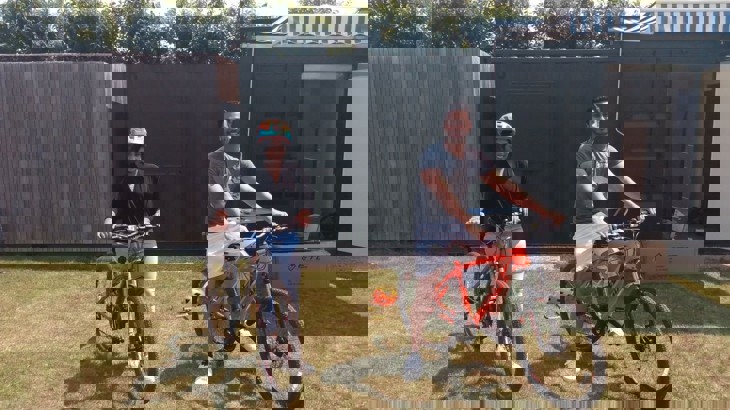 male and female sat on bicycles 