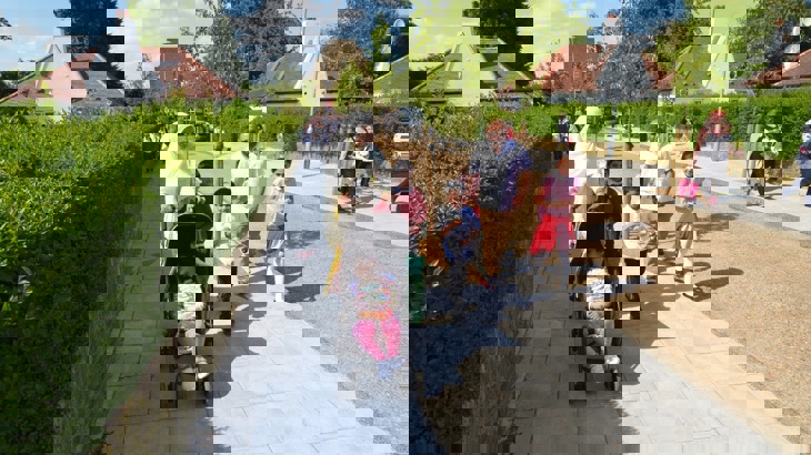 A family walk happily through a traffic free street