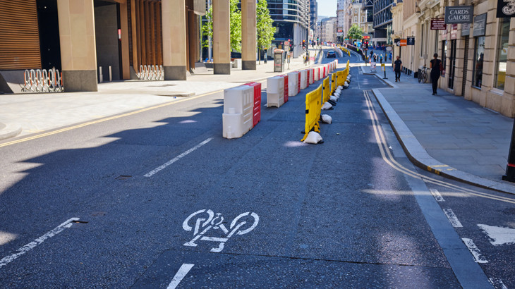A pop-up, temporary cycle lane in London using bollards to separate motor traffic from cyclists pictured here empty with nobody using it.