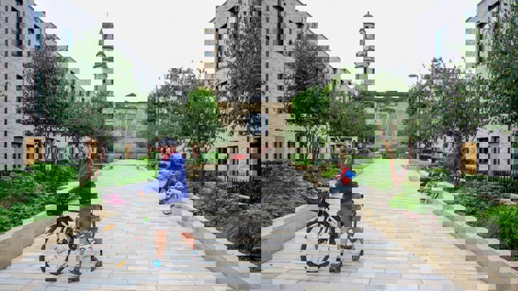 man with bike in public square - Salford Low Traffic Neighbourhood