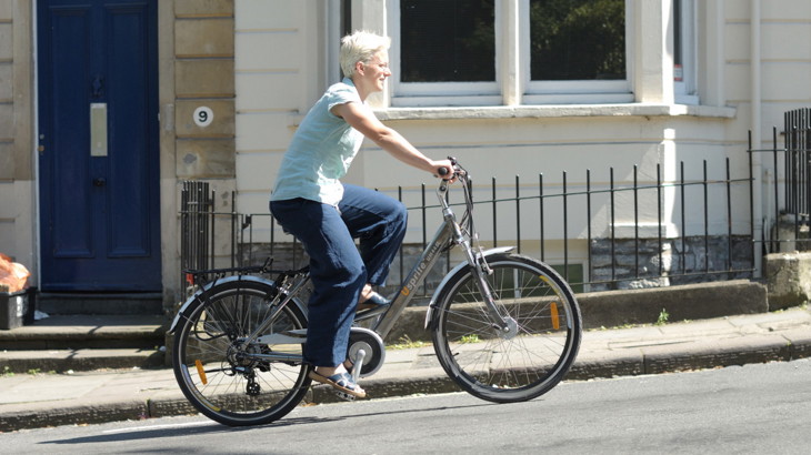 Woman riding ebike up a hill 