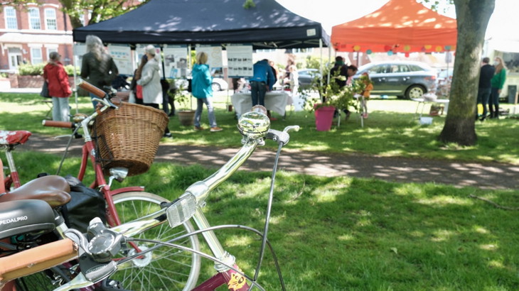 marquee outside with bunting, inside are noticeboards and stalls