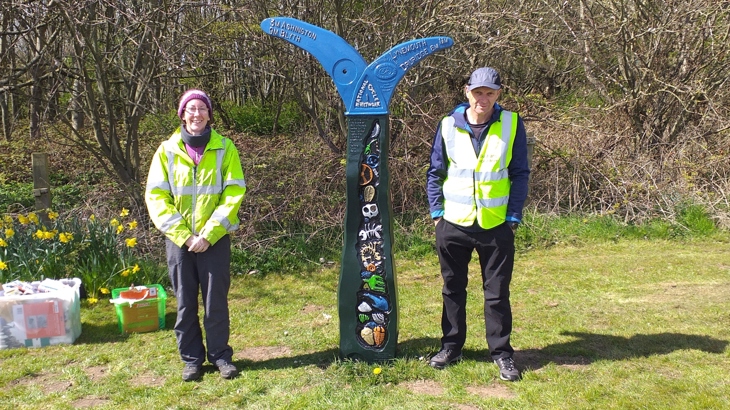 Volunteers next to milepost on National Route 1