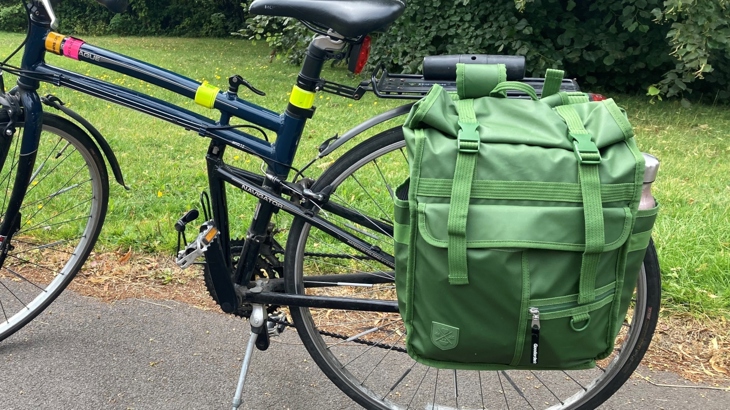 Green backpack from Goodordering attached to a pannier rack.