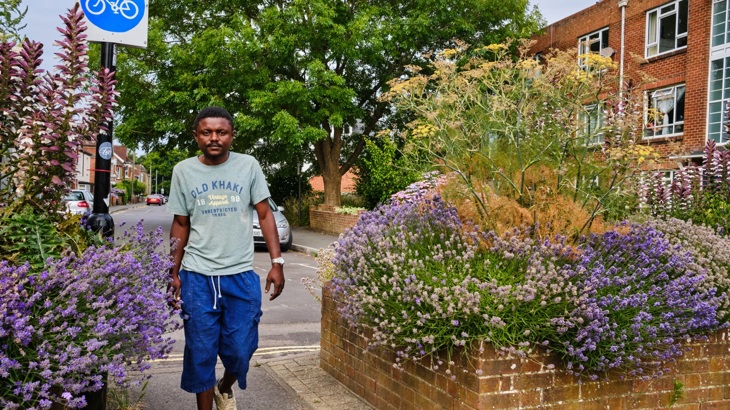 Man walking through planters full of lavender in Southampton