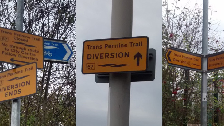 Trans Pennine Trail route diversion sign with a upwards pointing arrow and Route number 67, mounted on a pole